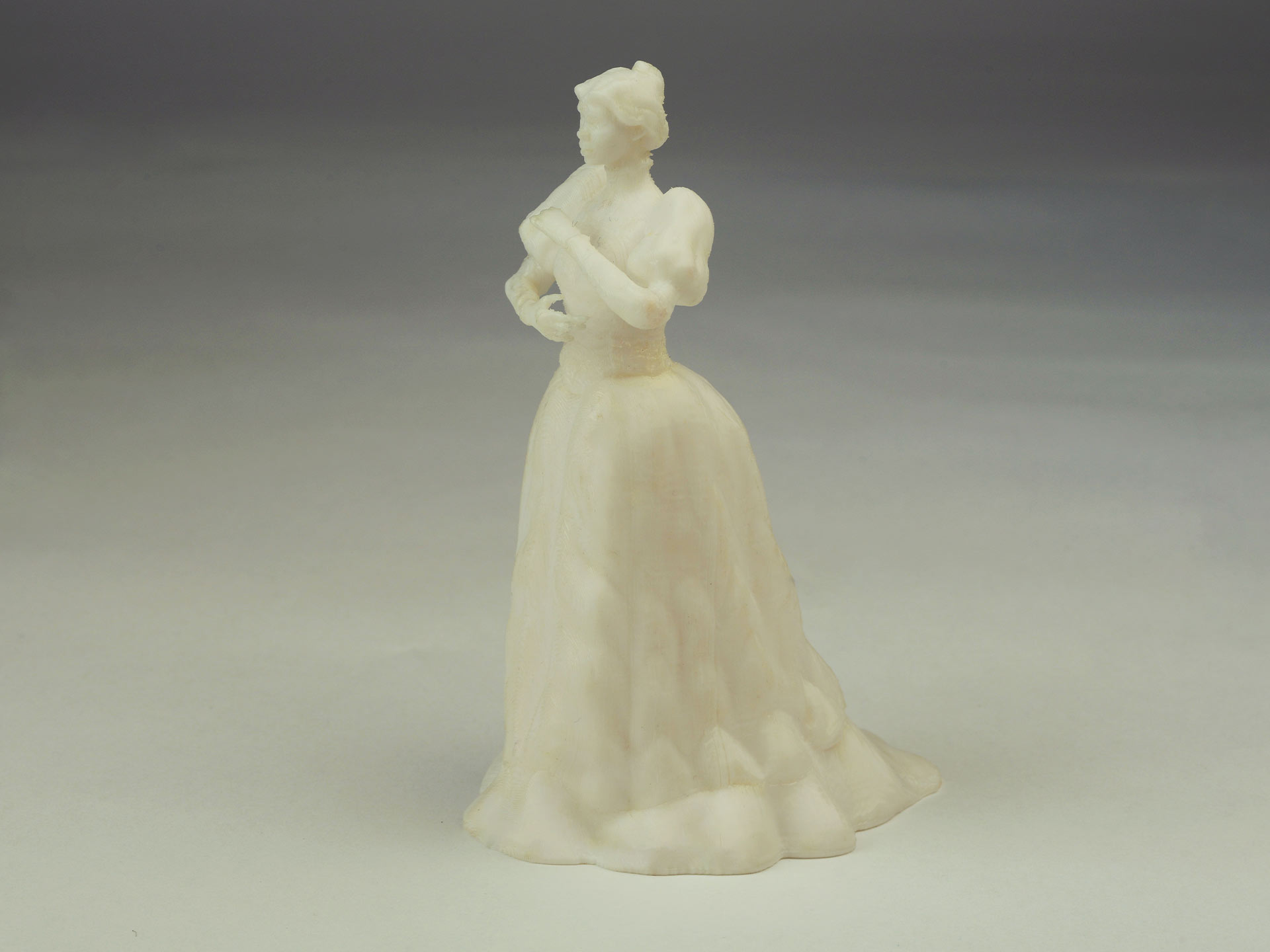 A photograph of a 3d print of a woman in a large dress